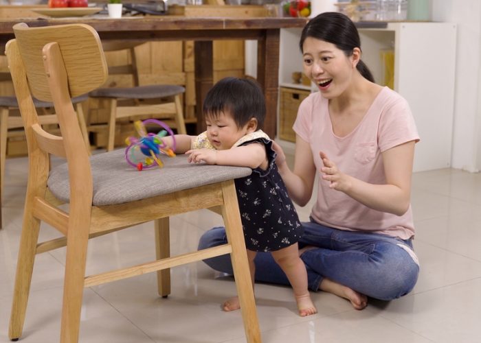 Asian,Parent,Seated,On,The,Floor,At,Home,Is,Clapping