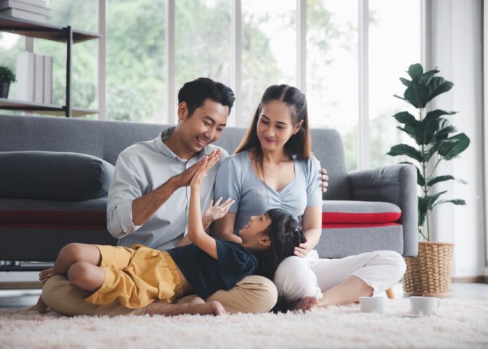 Asian,Kid,Cute,Girl,Lying,On,Mom,And,Dad,Happy