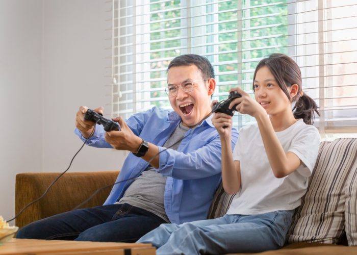 Asian,Father,And,Daughter,Playing,Video,Games,At,Home,,People