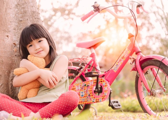 Cute,Little,Asian,Girl,Hug,Doll,Sitting,Under,A,Tree